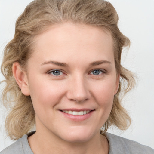 Joyful white young-adult female with medium  brown hair and blue eyes