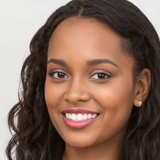 Joyful latino young-adult female with long  brown hair and brown eyes