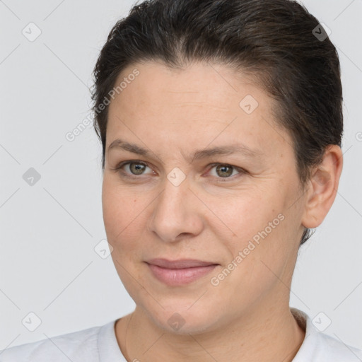 Joyful white adult female with short  brown hair and brown eyes