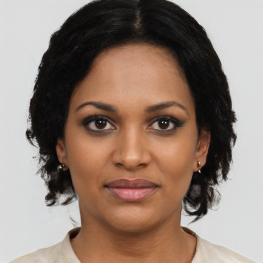 Joyful black young-adult female with medium  black hair and brown eyes