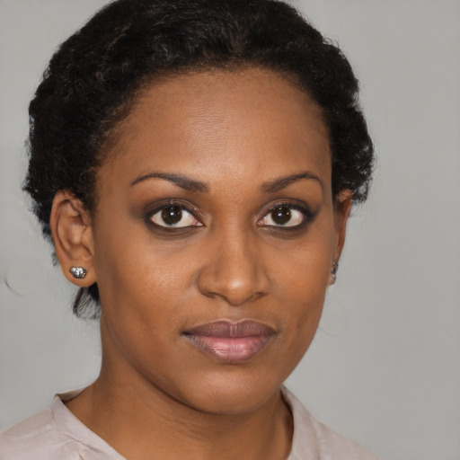 Joyful black young-adult female with short  brown hair and brown eyes
