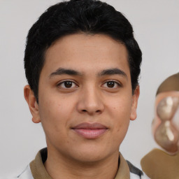 Joyful latino young-adult male with short  black hair and brown eyes