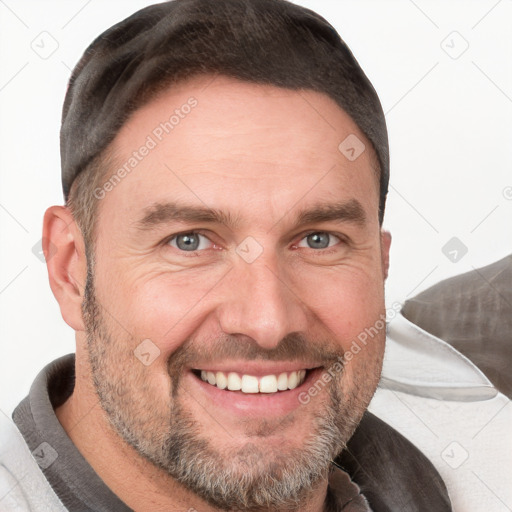 Joyful white adult male with short  brown hair and grey eyes