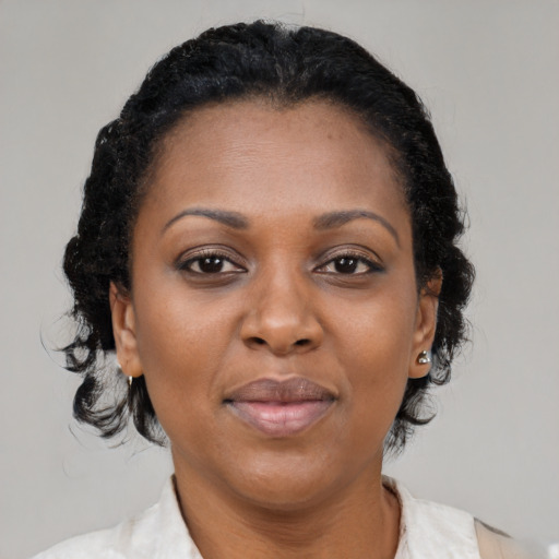 Joyful black adult female with medium  brown hair and brown eyes