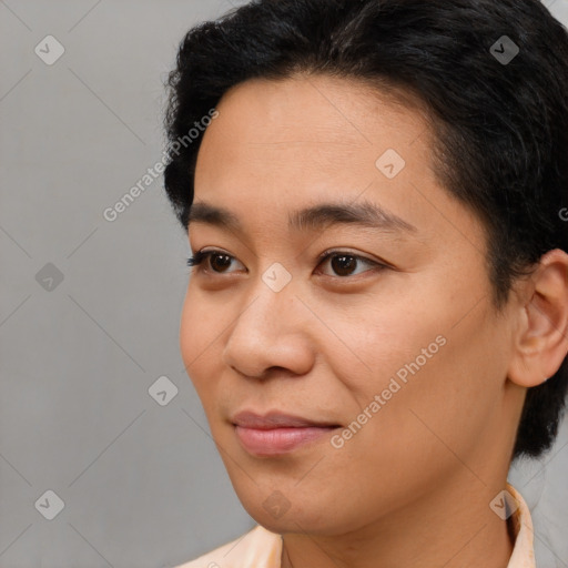 Joyful asian young-adult male with short  brown hair and brown eyes