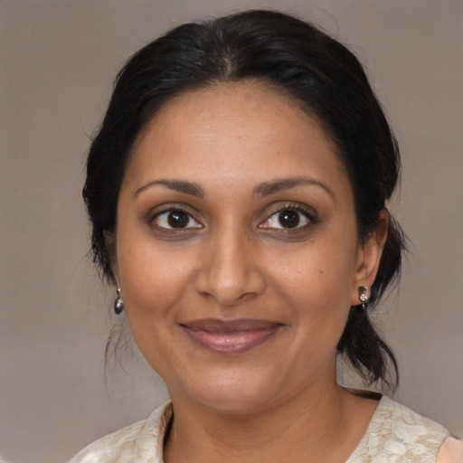 Joyful black adult female with medium  brown hair and brown eyes
