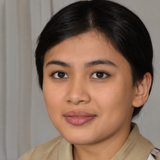 Joyful latino young-adult female with medium  brown hair and brown eyes