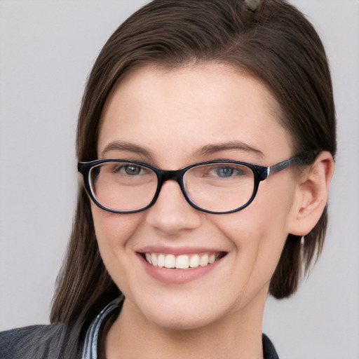 Joyful white young-adult female with medium  brown hair and grey eyes