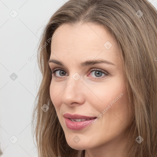 Joyful white young-adult female with long  brown hair and grey eyes