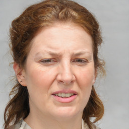 Joyful white adult female with medium  brown hair and blue eyes