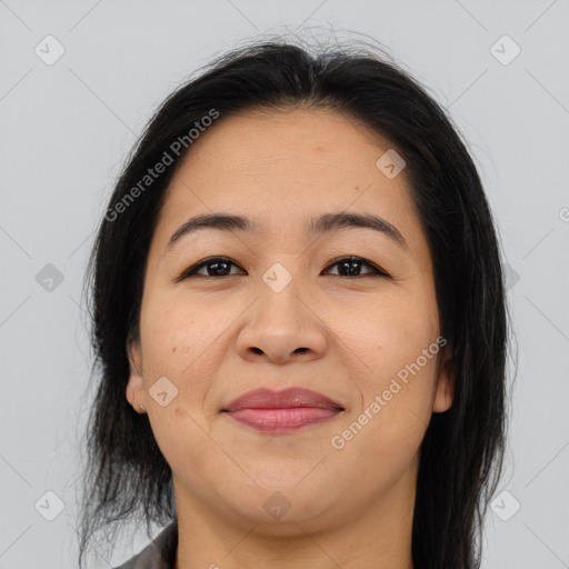 Joyful latino adult female with medium  brown hair and brown eyes