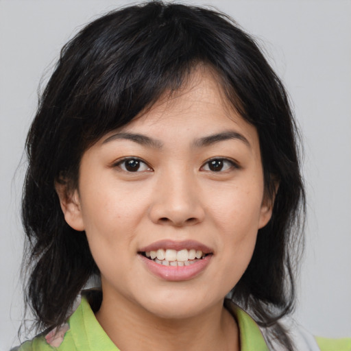 Joyful asian young-adult female with medium  brown hair and brown eyes