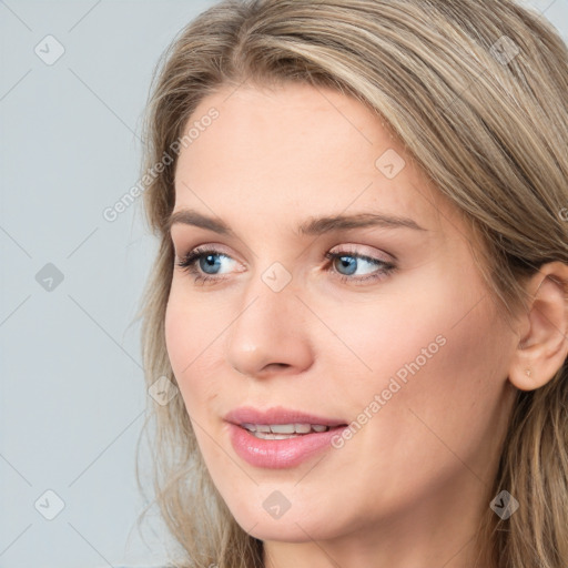 Joyful white young-adult female with long  brown hair and blue eyes