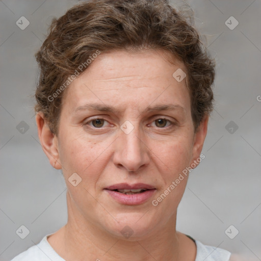 Joyful white adult female with short  brown hair and grey eyes