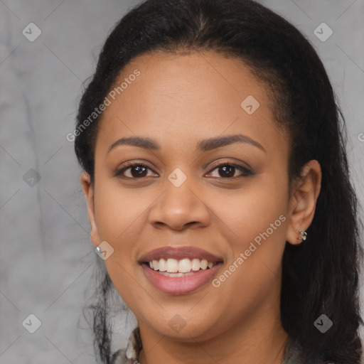 Joyful black young-adult female with long  black hair and brown eyes