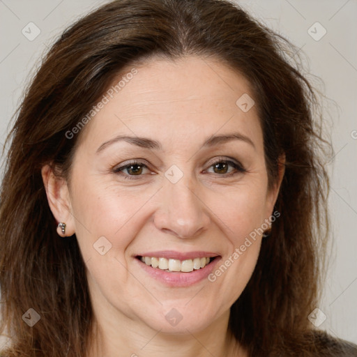 Joyful white adult female with long  brown hair and brown eyes