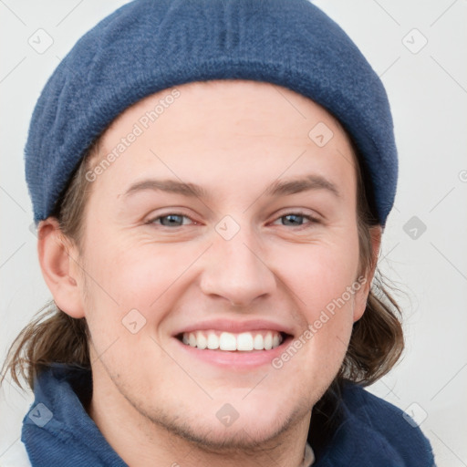 Joyful white young-adult female with short  brown hair and blue eyes