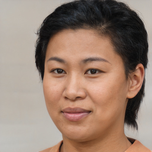 Joyful asian adult female with medium  brown hair and brown eyes