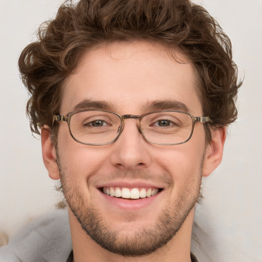 Joyful white young-adult male with short  brown hair and blue eyes