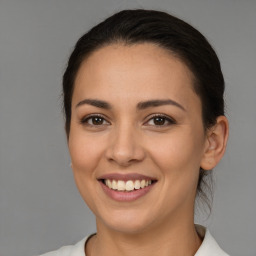 Joyful white young-adult female with medium  brown hair and brown eyes