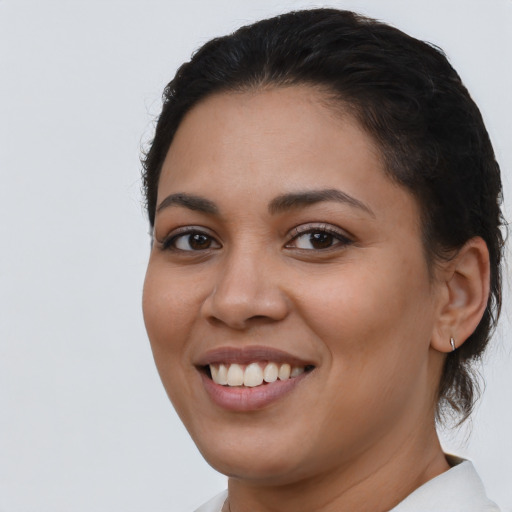Joyful latino young-adult female with short  brown hair and brown eyes