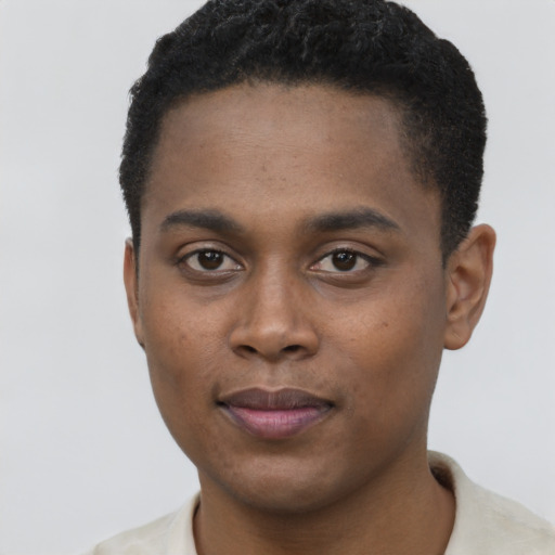 Joyful black young-adult male with short  black hair and brown eyes