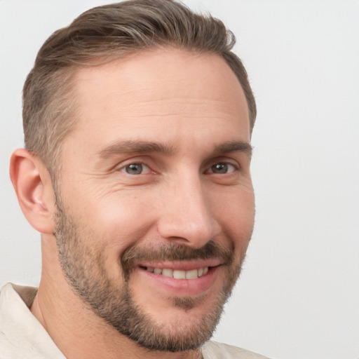 Joyful white adult male with short  brown hair and brown eyes