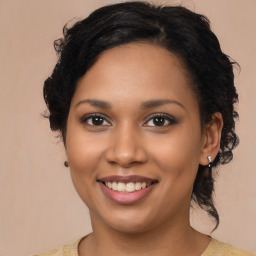 Joyful black young-adult female with medium  brown hair and brown eyes