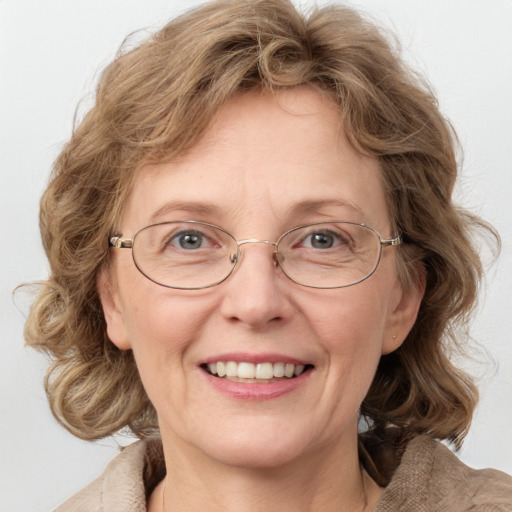 Joyful white adult female with medium  brown hair and blue eyes