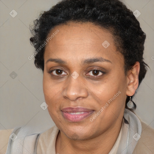 Joyful black adult female with short  brown hair and brown eyes