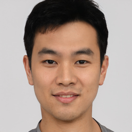 Joyful asian young-adult male with short  black hair and brown eyes