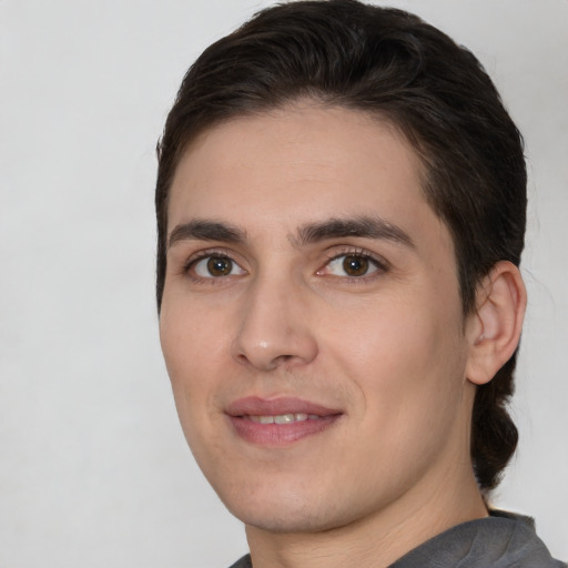 Joyful white young-adult male with short  brown hair and brown eyes