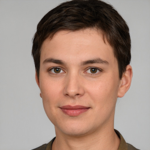 Joyful white young-adult male with short  brown hair and grey eyes