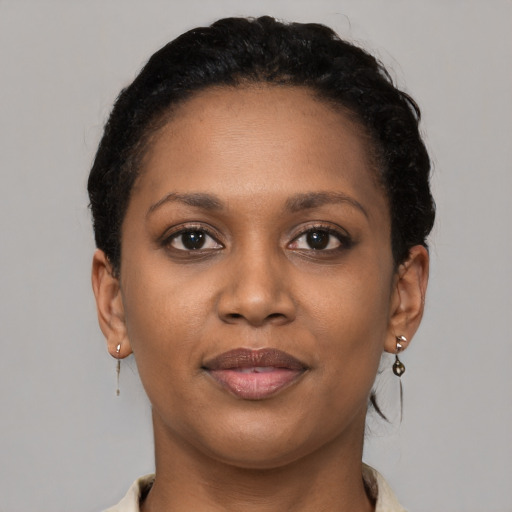 Joyful black young-adult female with short  brown hair and brown eyes