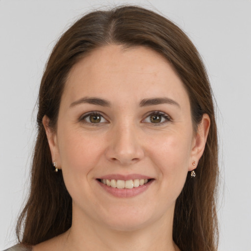 Joyful white young-adult female with long  brown hair and grey eyes