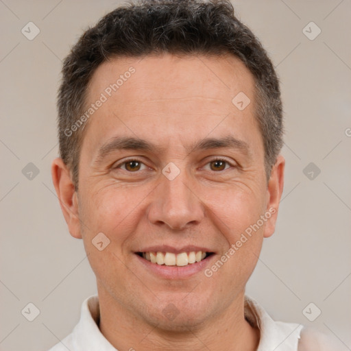 Joyful white adult male with short  brown hair and brown eyes