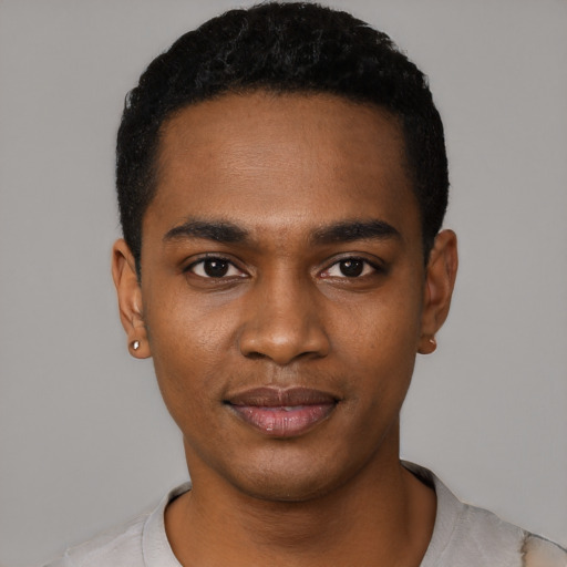 Joyful black young-adult male with short  black hair and brown eyes