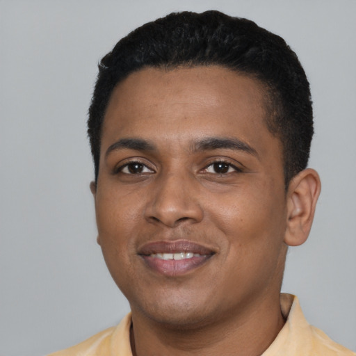 Joyful black young-adult male with short  black hair and brown eyes