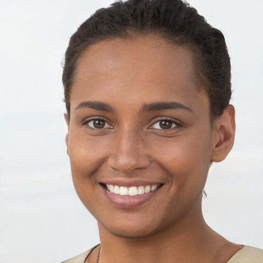 Joyful black young-adult female with short  brown hair and brown eyes