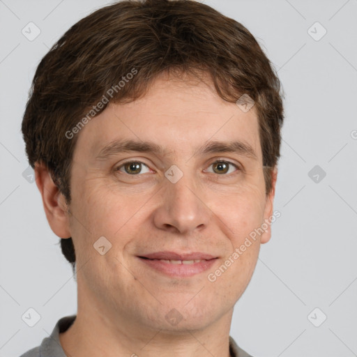 Joyful white adult male with short  brown hair and grey eyes