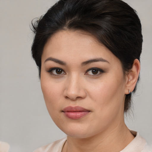 Joyful asian young-adult female with medium  brown hair and brown eyes