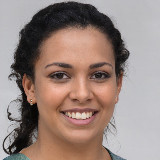 Joyful latino young-adult female with medium  brown hair and brown eyes