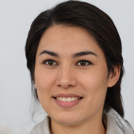 Joyful white young-adult female with medium  brown hair and brown eyes