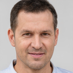 Joyful white adult male with short  brown hair and brown eyes