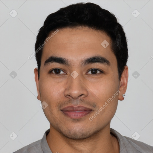 Joyful latino young-adult male with short  black hair and brown eyes