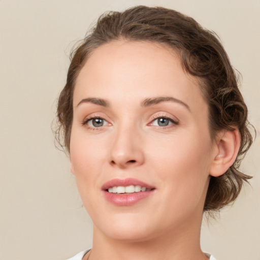 Joyful white young-adult female with medium  brown hair and green eyes