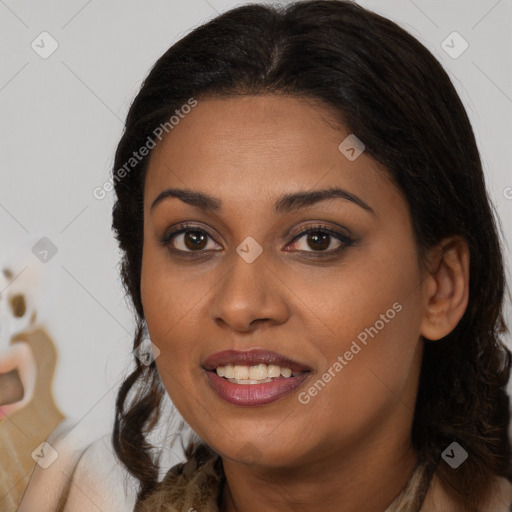 Joyful black young-adult female with long  brown hair and brown eyes