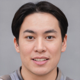 Joyful asian young-adult male with short  brown hair and brown eyes