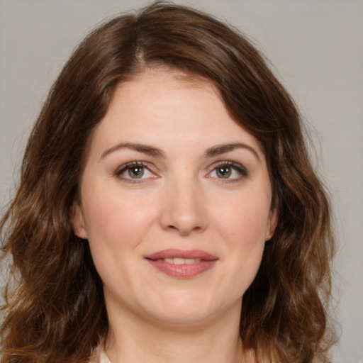 Joyful white young-adult female with medium  brown hair and green eyes