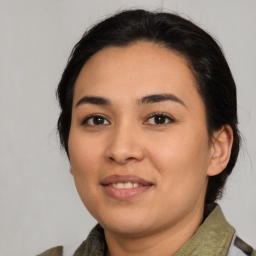 Joyful latino young-adult female with medium  brown hair and brown eyes
